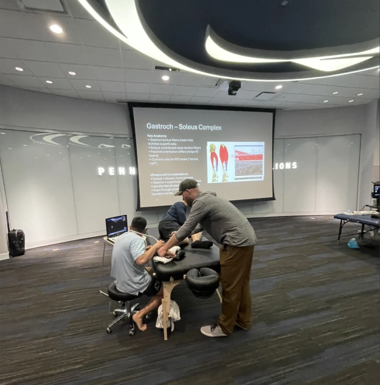 Clinicians practicing lower-leg ultrasound scanning during a hands-on Pura Health workshop